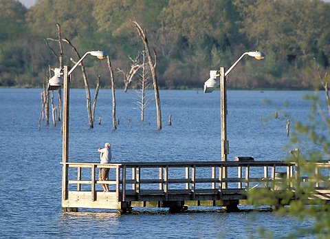 One of the proposed regulations would limit the number of fishing rods a person could use in state parks. This gentleman, fishing at Purtis Creek State Park, would be fine. Photo by Earl Nottingham, TPWD. pier