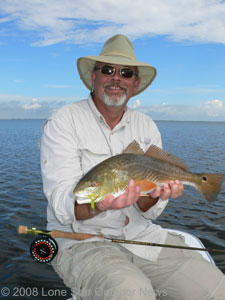 Steve Faris shows a red drum caught near Rockport while fishing with Capt Paul Brown. Photos by David J. Sams