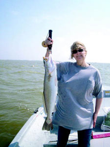 Birthday bash: Carol Watson holds the 31-inch trout she landed and released on her 53rd birthday. Photo by Michael Angell.