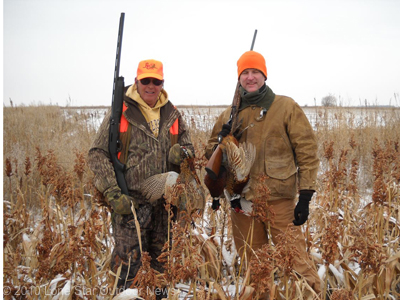 A pair of hunters enjoy a few birds and a few flakes of snow on their annual Kansas pheasant hunt. Photo by David J. Sams, LSONews.com.