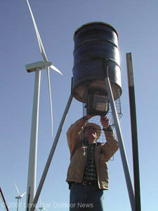 Winds of change: David Coleman of the Galbraith Family Ranch near Abilene checks a feeder near one of the ranch�s wind turbines. Photo by Craig Nyhus.