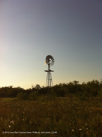 Winds of concern: A wind turbine hovers over a deer blind in Taylor County. Photo by Craig Nyhus.